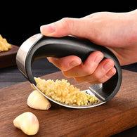 Garlic Crusher crushing garlic cloves effortlessly.